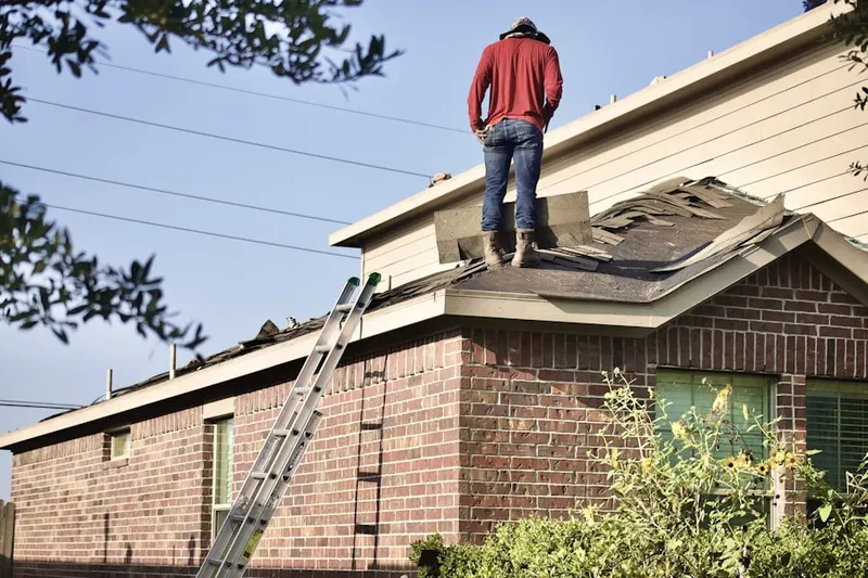 Professional roofer working on a residential roof in South Niles